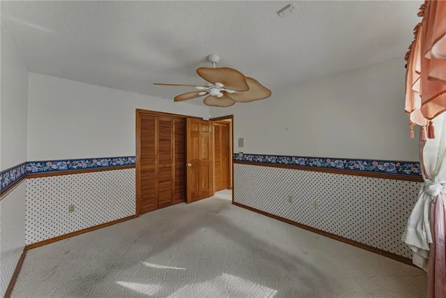 a view of a room with wooden floor and windows