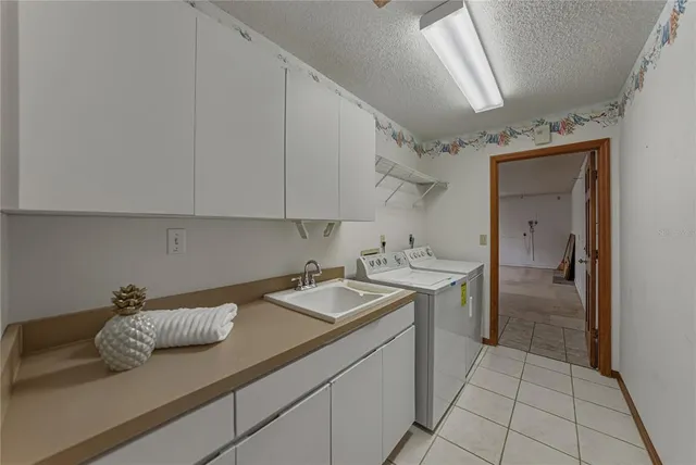 a view of a house with a yard and tree