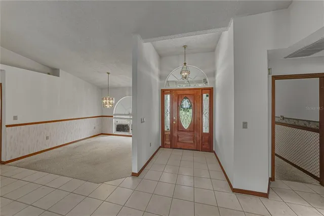 a view of an entryway with chandelier