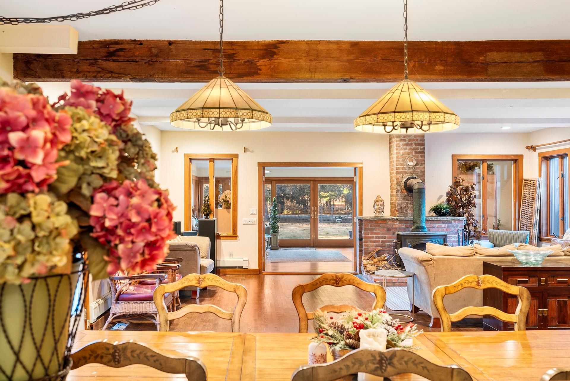 61 Lower 7 Ponds Road Water Mill, NY 11976 - Photo 20 of 43 a living room with a chandelier furniture and a chandelier