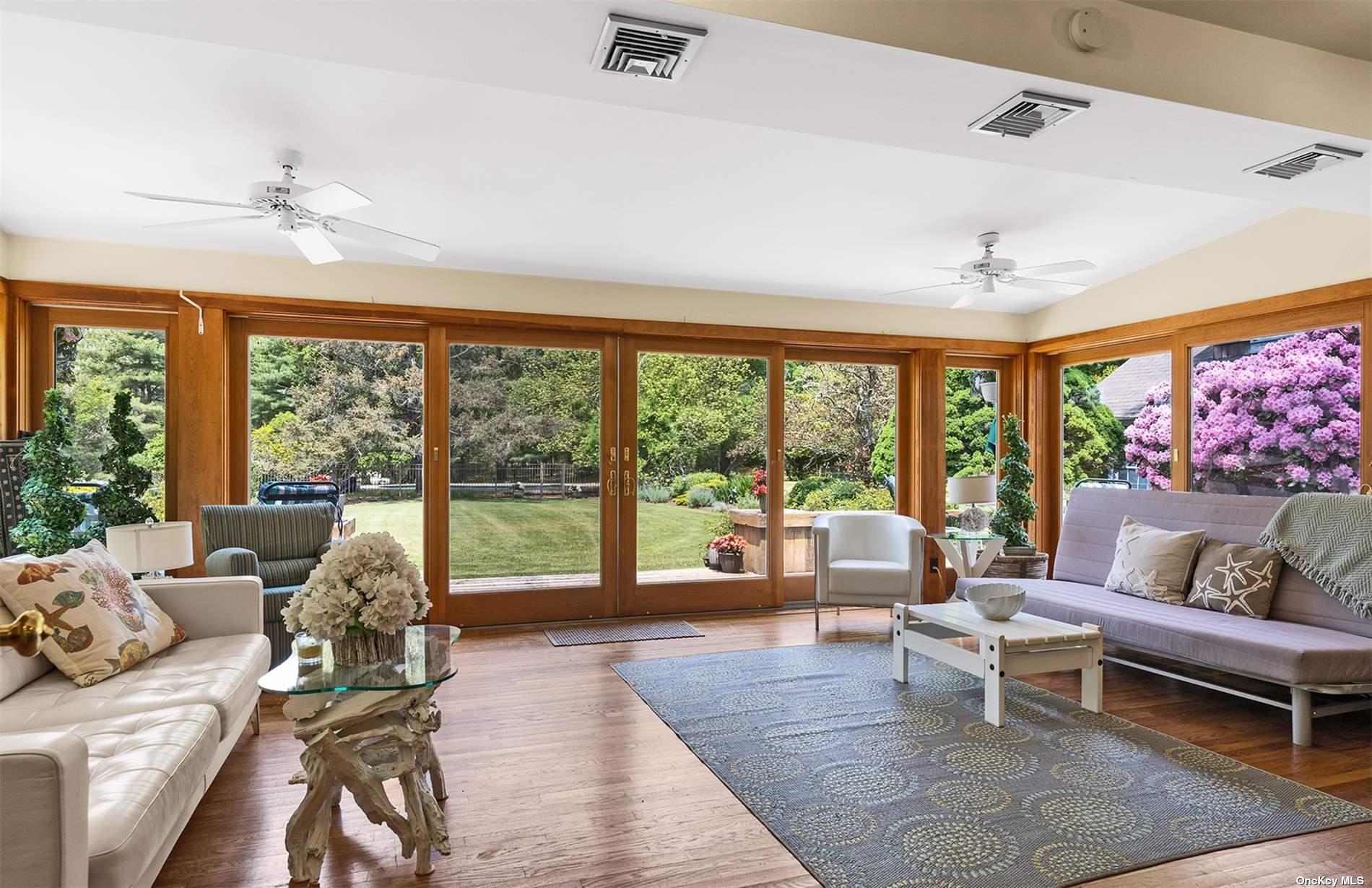 61 Lower 7 Ponds Road Water Mill, NY 11976 - Photo 22 of 43 a living room with furniture and a large window