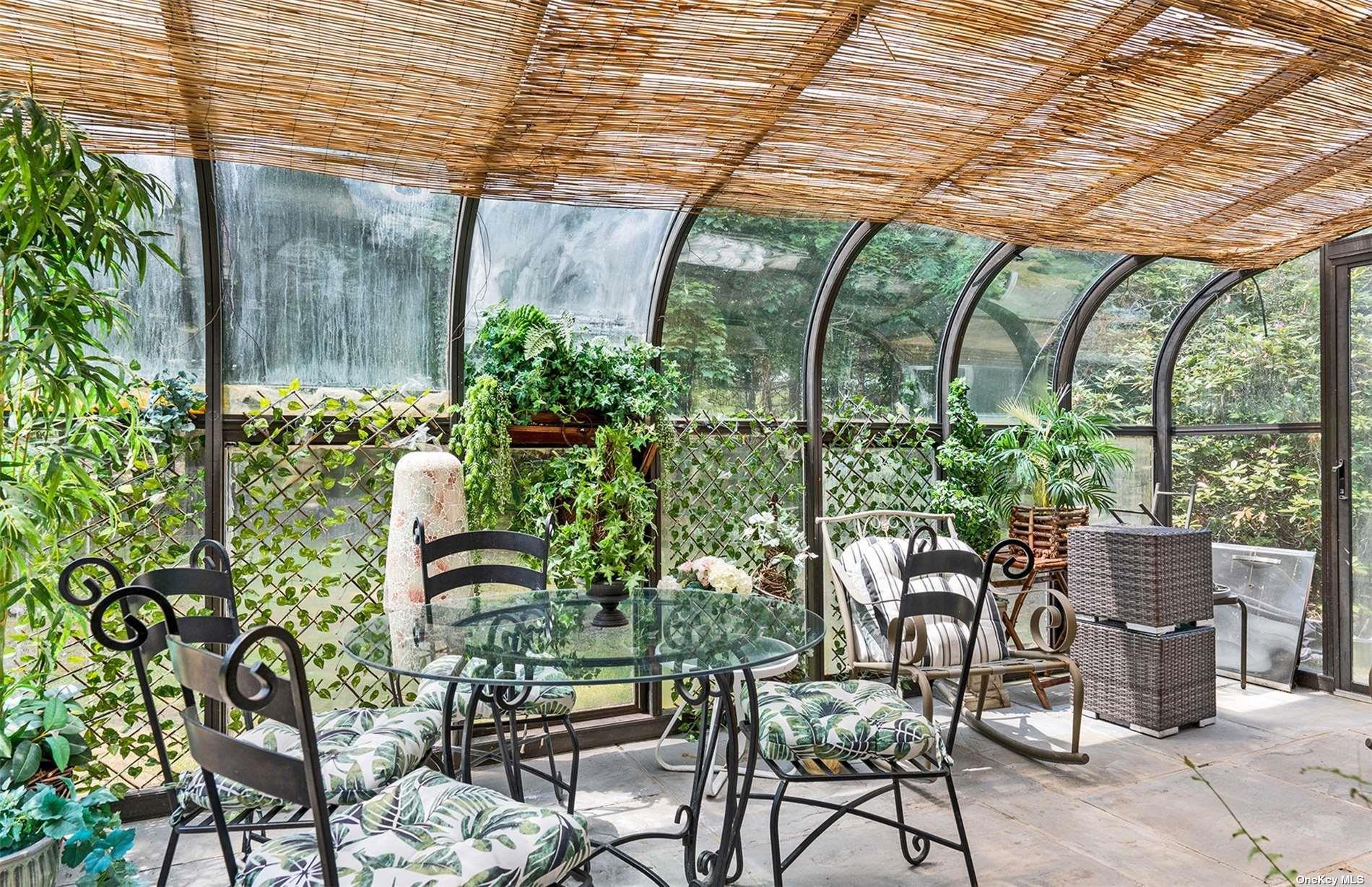 61 Lower 7 Ponds Road Water Mill, NY 11976 - Photo 24 of 43 a patio with table and chairs and potted plants