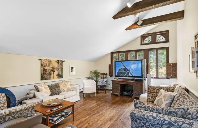 a living room with furniture a fireplace and a large window
