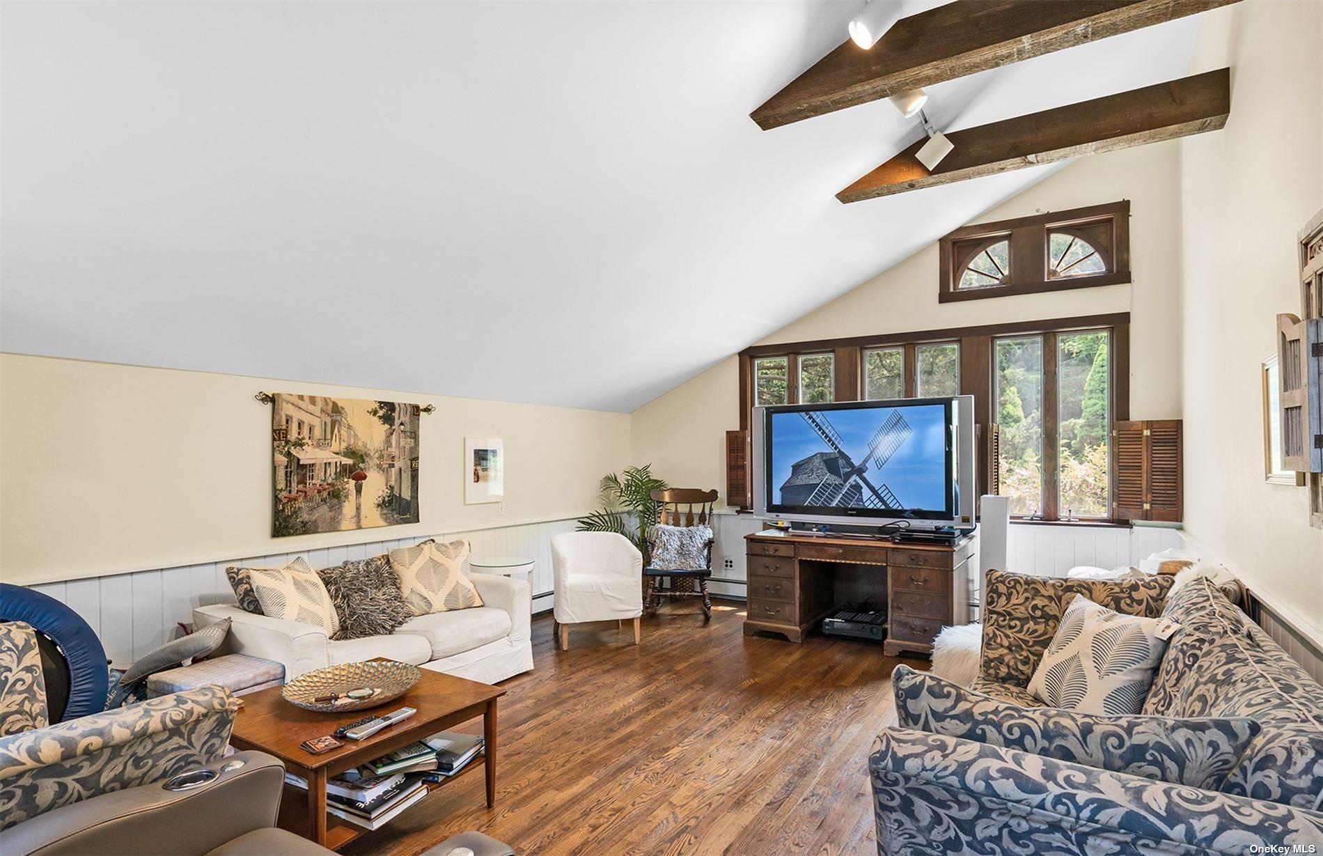 61 Lower 7 Ponds Road Water Mill, NY 11976 - Photo 26 of 43 a living room with furniture a fireplace and a large window