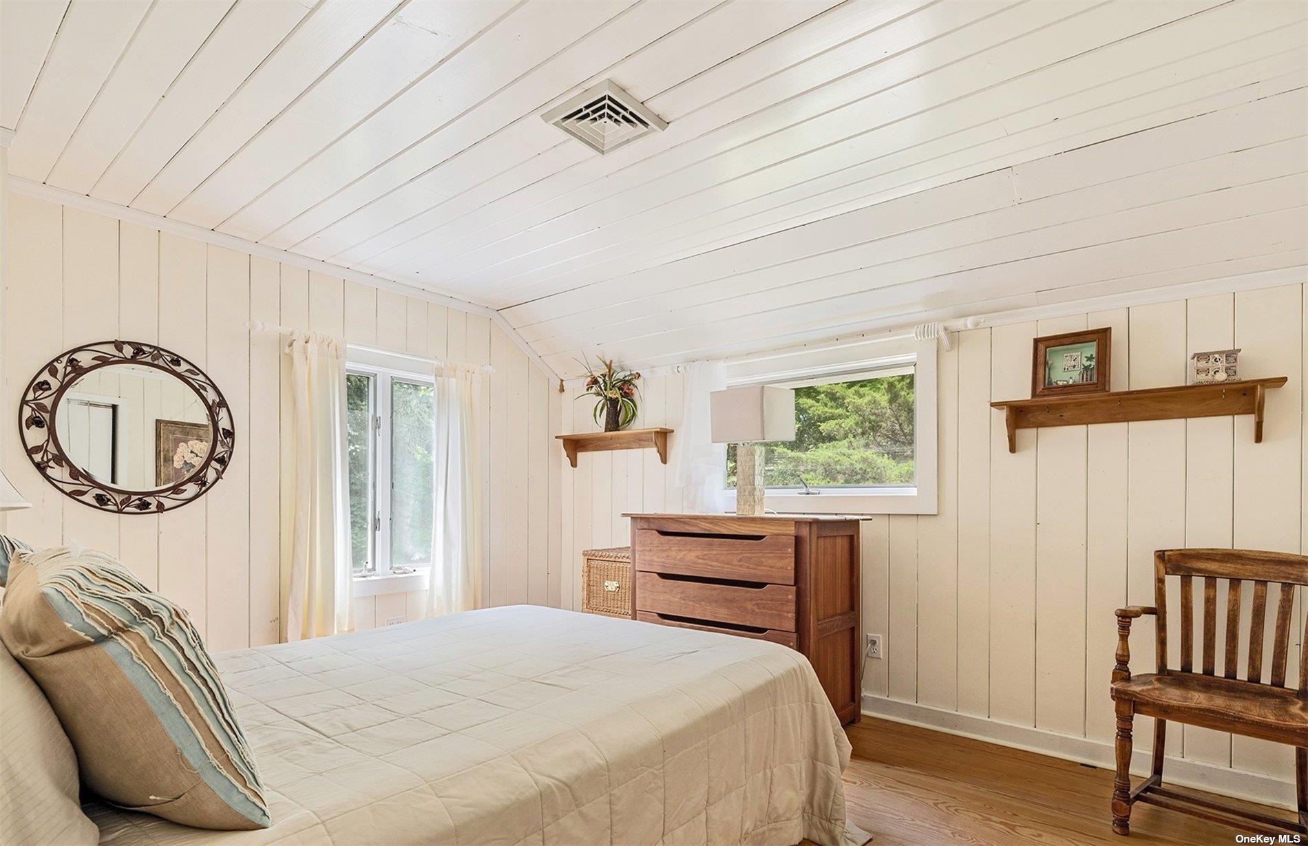 61 Lower 7 Ponds Road Water Mill, NY 11976 - Photo 33 of 43 a bedroom with a bed and a window