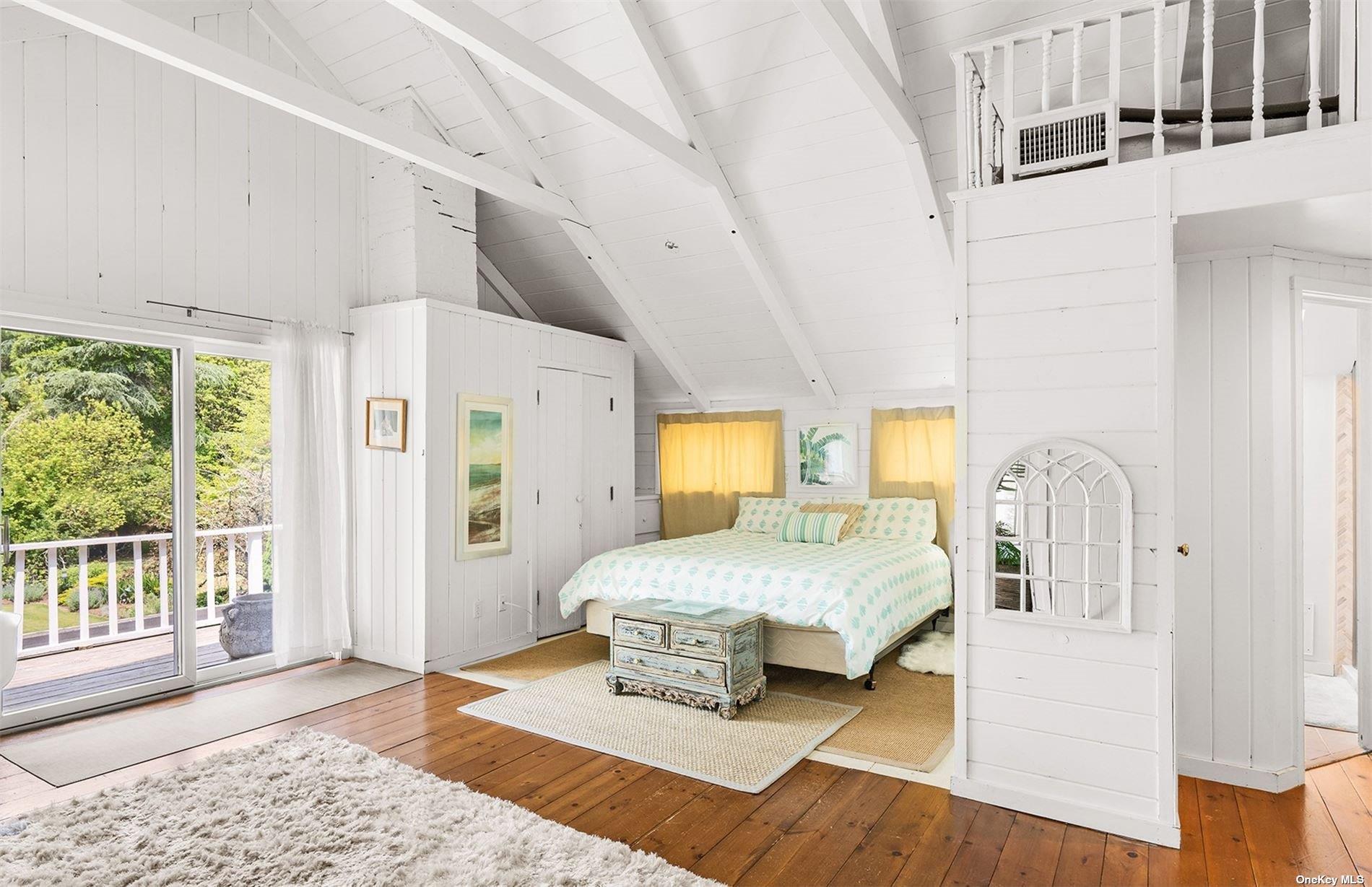 61 Lower 7 Ponds Road Water Mill, NY 11976 - Photo 34 of 43 a bedroom with a bed a table and chair