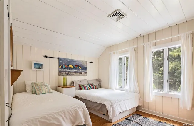 a bedroom with two beds and a window