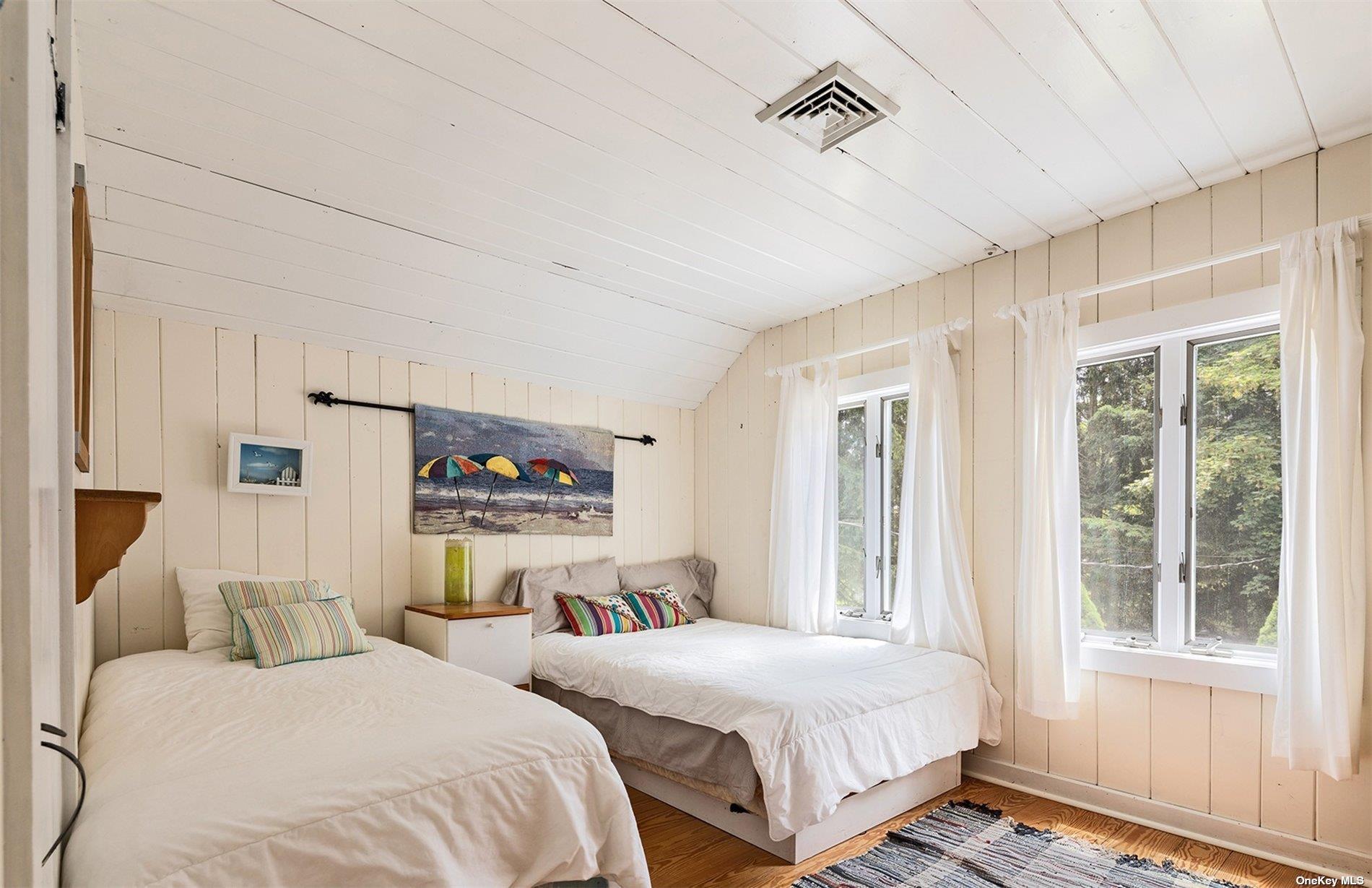 61 Lower 7 Ponds Road Water Mill, NY 11976 - Photo 35 of 43 a bedroom with two beds and a window