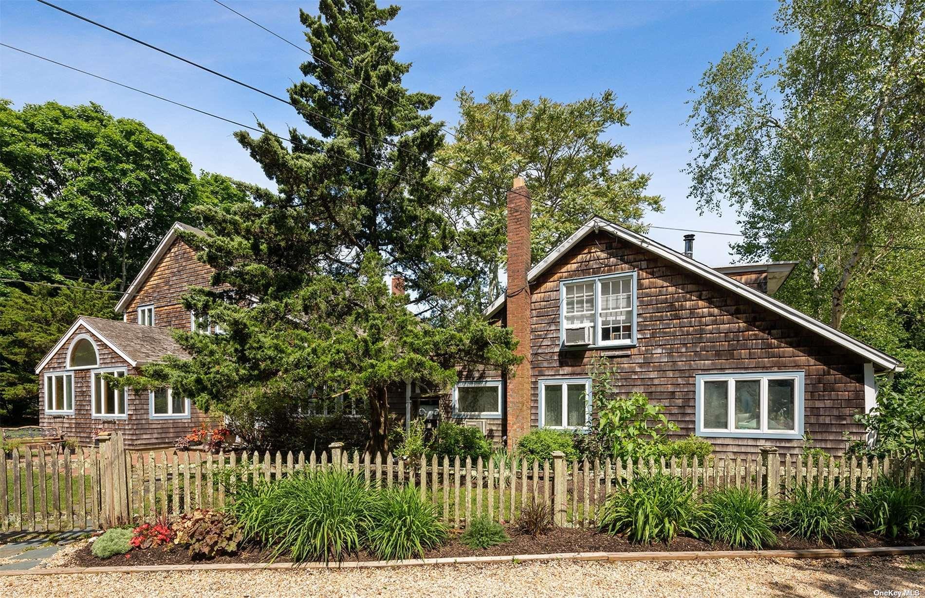 61 Lower 7 Ponds Road Water Mill, NY 11976 - Photo 43 of 43 a front view of a house with a garden
