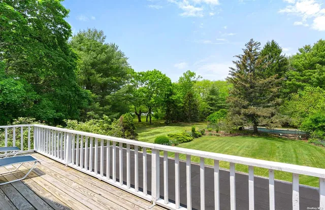 a balcony with wooden floor and fence