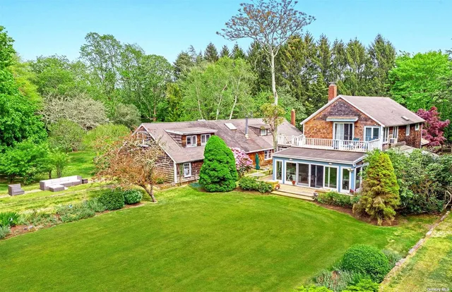 a aerial view of a house with yard and green space