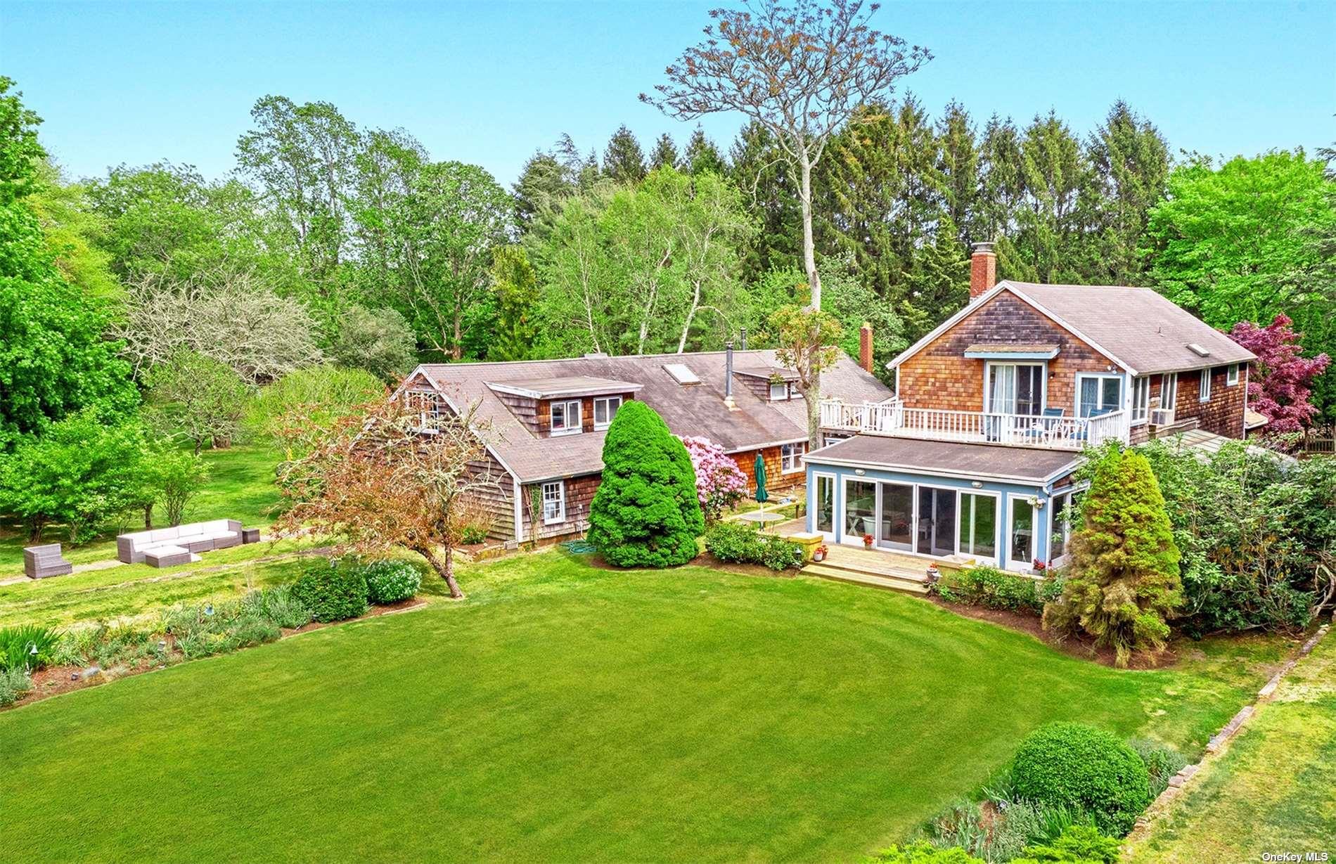 61 Lower 7 Ponds Road Water Mill, NY 11976 - Photo 9 of 43 a aerial view of a house with yard and green space