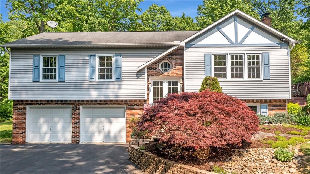 142 Waltz Mill Road Ruffs Dale, PA 15679 - Photo 1 of 47 a front view of a house with a yard and garage