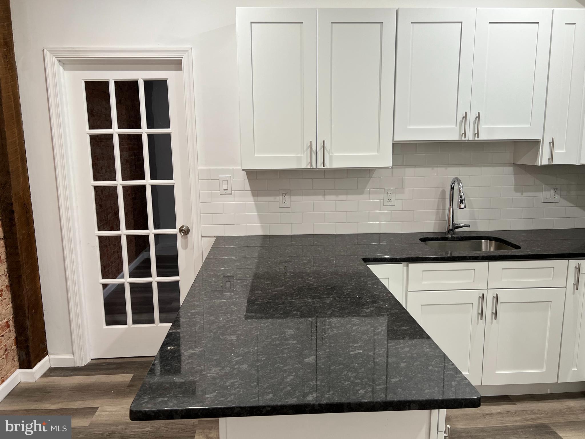 2814 Master Street, Unit B Philadelphia, PA 19121 - Photo 4 of 13 a view of kitchen with granite countertop cabinets