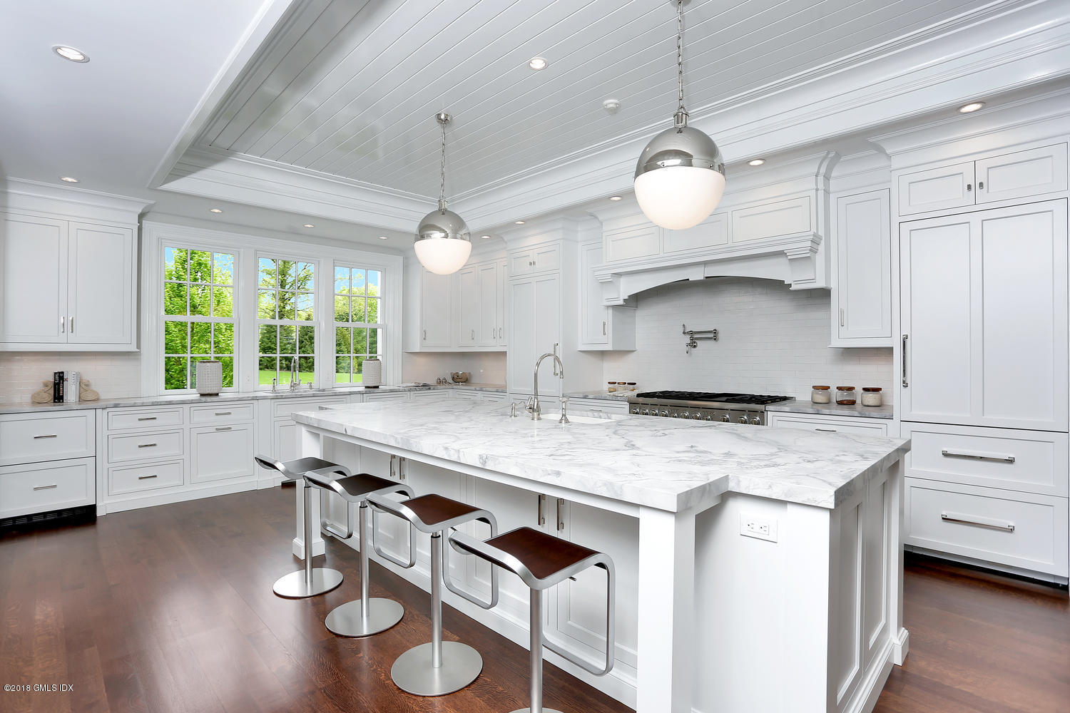 272 Round Hill Road Greenwich, CT 06831 - Photo 13 of 33 a kitchen with a stove chandelier and wooden floor
