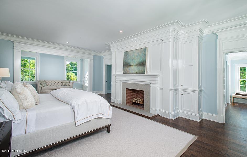 272 Round Hill Road Greenwich, CT 06831 - Photo 22 of 33 a bedroom with a bed and a fireplace
