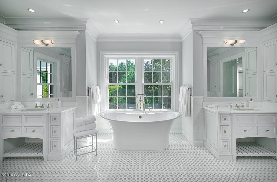 272 Round Hill Road Greenwich, CT 06831 - Photo 23 of 33 a spacious bathroom with a double vanity sink a mirror and a bathtub