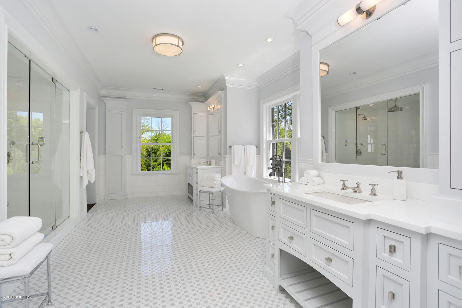 272 Round Hill Road Greenwich, CT 06831 - Photo 24 of 33 a spacious bathroom with a double vanity sink a large mirror a shower and a bathtub