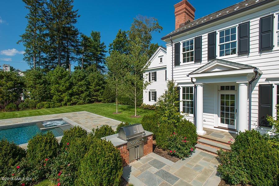 272 Round Hill Road Greenwich, CT 06831 - Photo 30 of 33 a front view of a house with garden