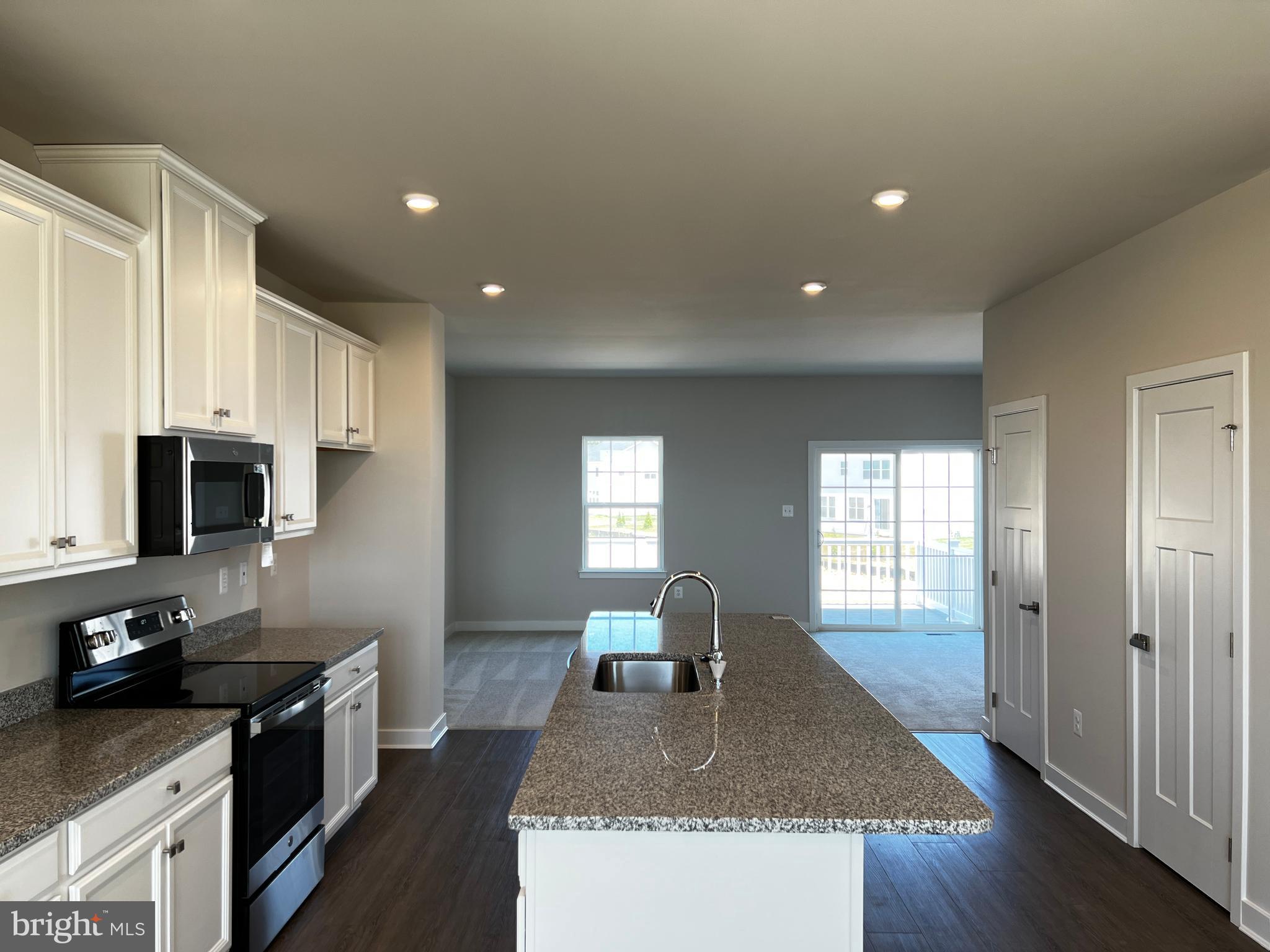 913 Ericcson Lane Middletown, DE 19709 - Photo 15 of 50 a kitchen with stainless steel appliances granite countertop a sink stove and refrigerator