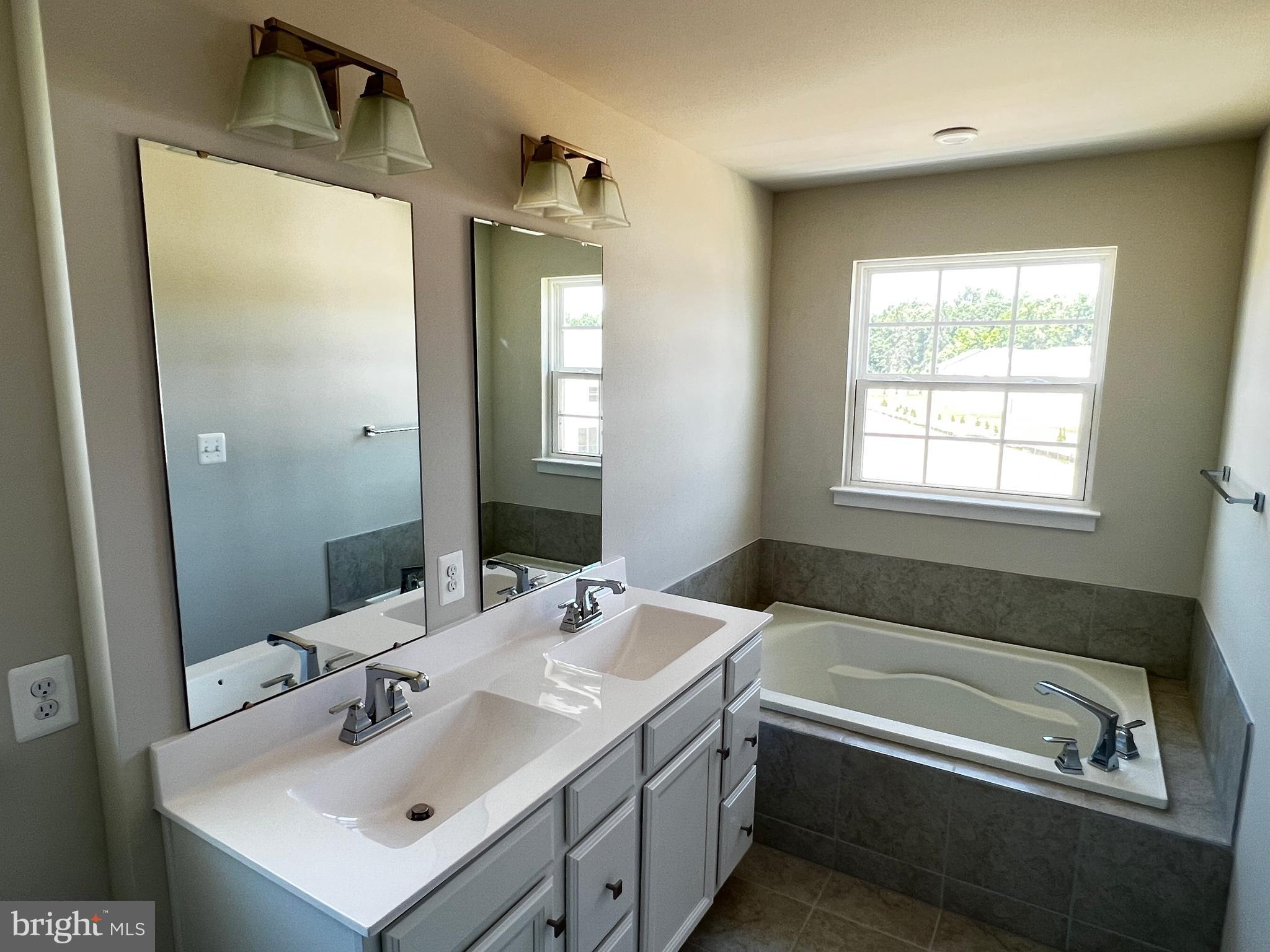 913 Ericcson Lane Middletown, DE 19709 - Photo 35 of 50 a bathroom with a tub sink and mirror