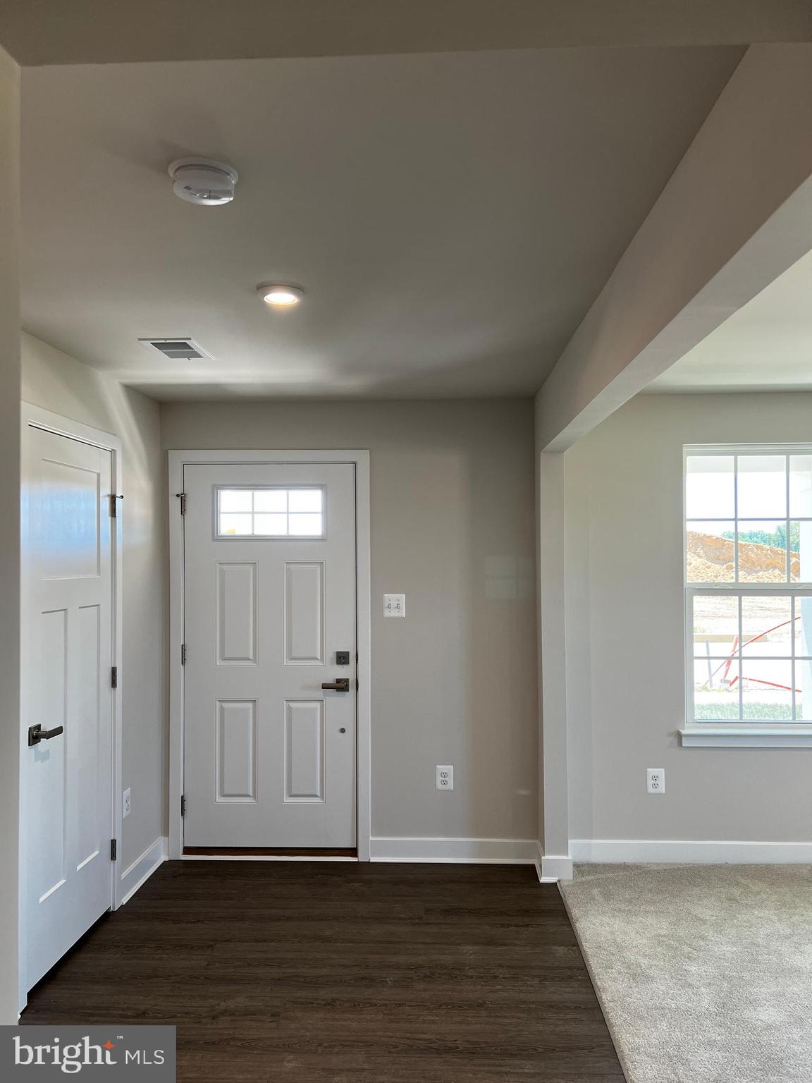 913 Ericcson Lane Middletown, DE 19709 - Photo 7 of 50 a view of an empty room with wooden floor and a window