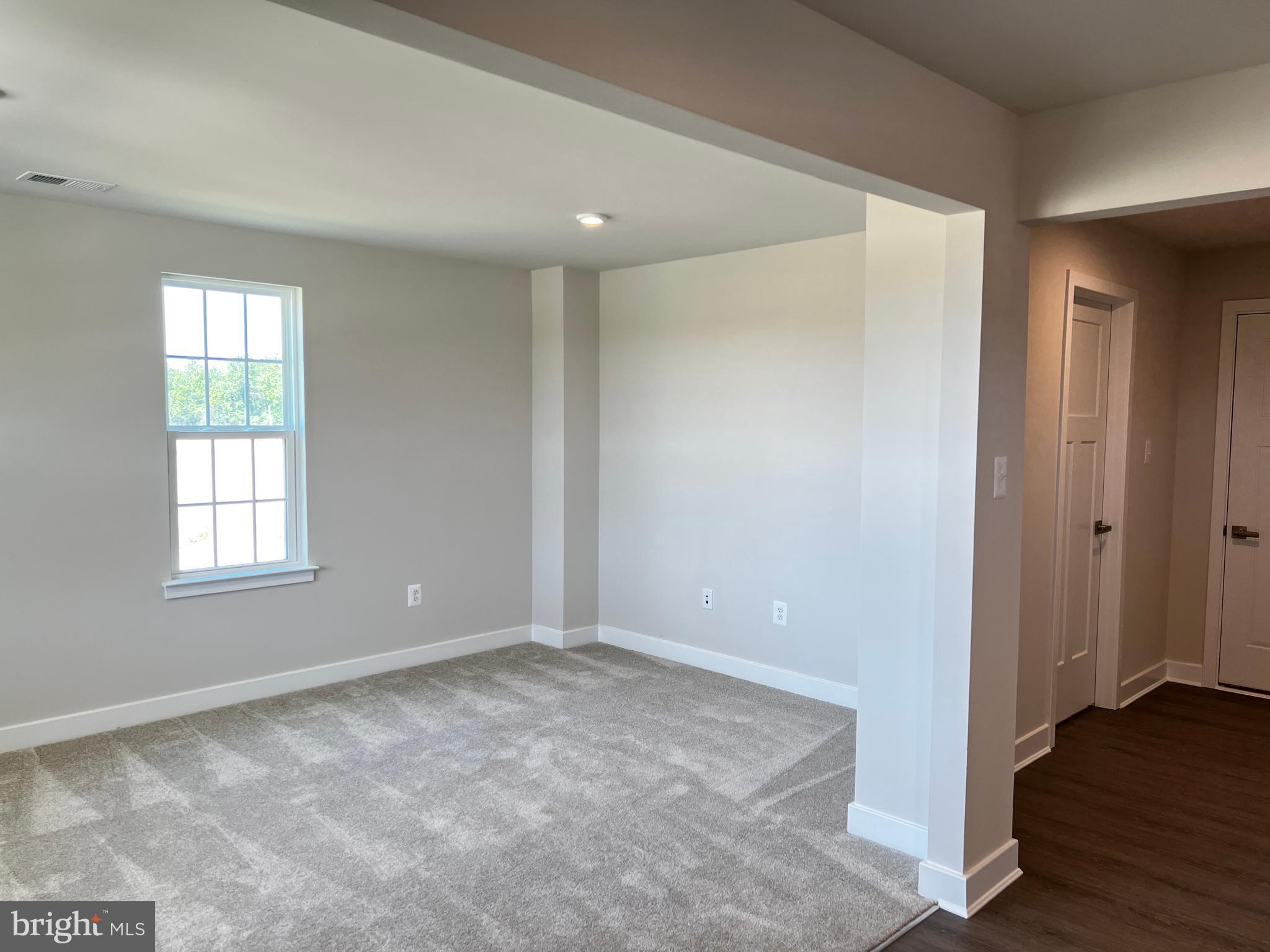 913 Ericcson Lane Middletown, DE 19709 - Photo 10 of 50 a view of an empty room with wooden floor and a window