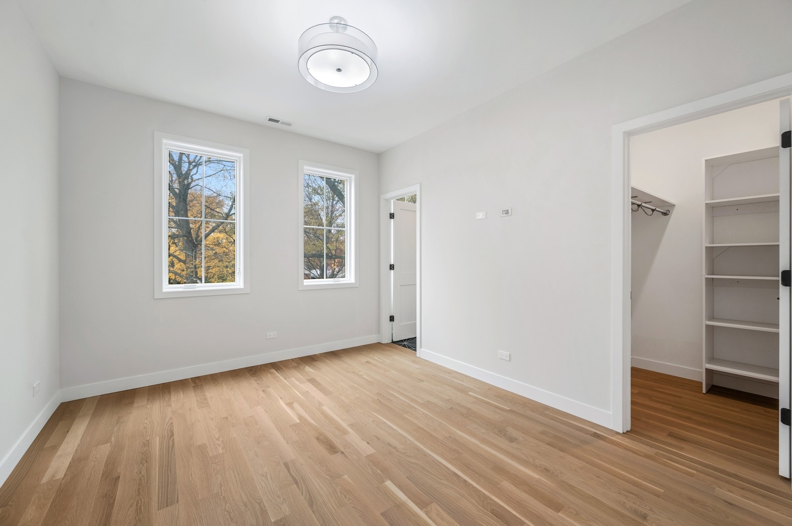 1816 Walnut Avenue Wilmette, IL 60091 - Photo 12 of 22 an empty room with wooden floor and windows
