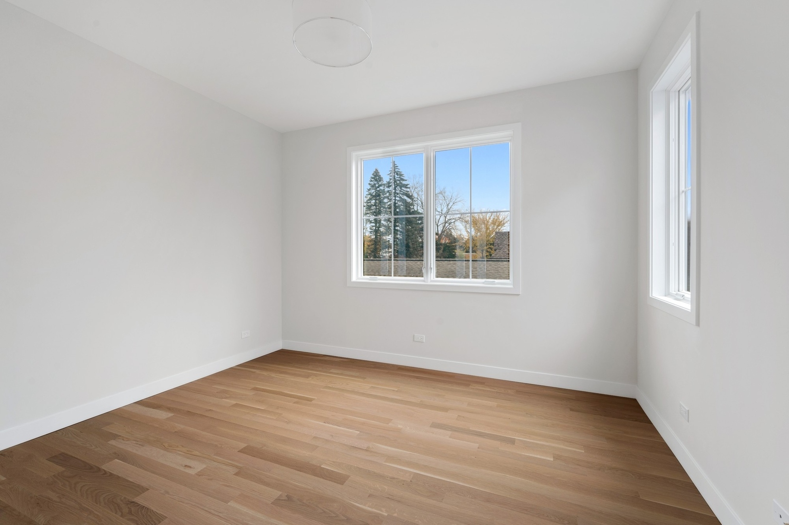 1816 Walnut Avenue Wilmette, IL 60091 - Photo 15 of 22 a view of an empty room with wooden floor and a window