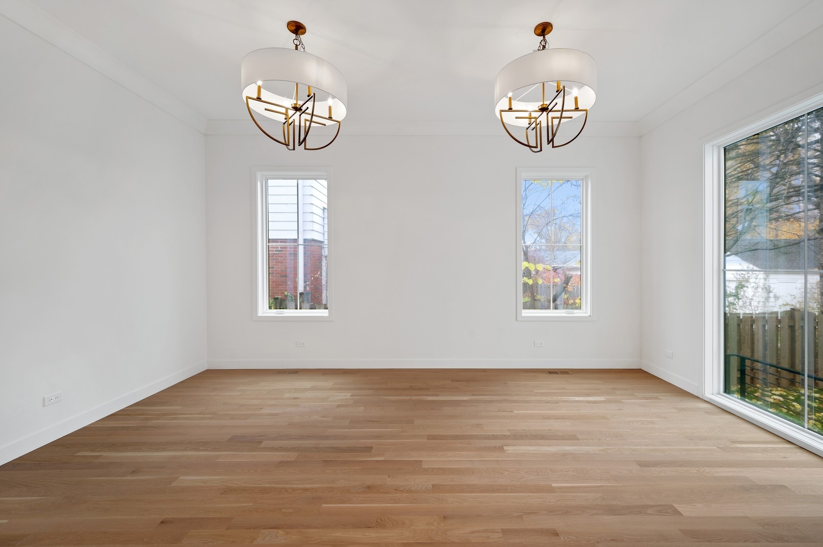 1816 Walnut Avenue Wilmette, IL 60091 - Photo 6 of 22 an empty room with wooden floor and windows