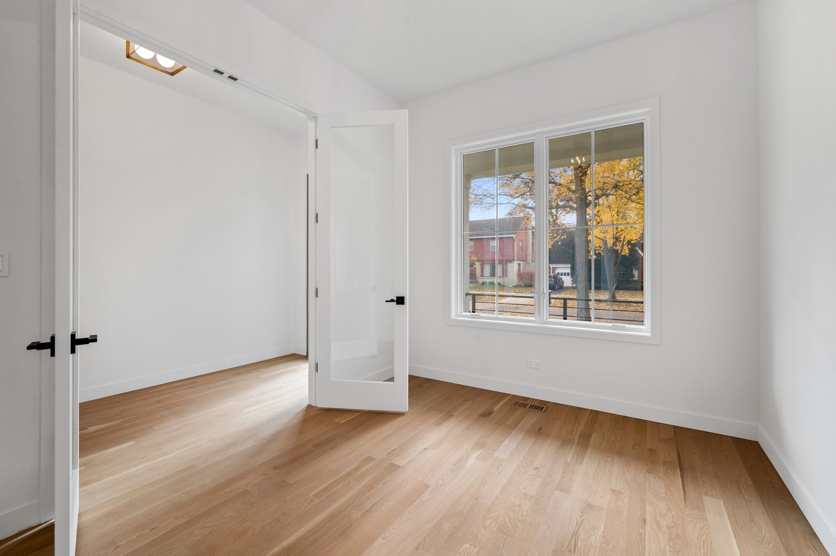 1816 Walnut Avenue Wilmette, IL 60091 - Photo 7 of 22 a view of an empty room with wooden floor and a window
