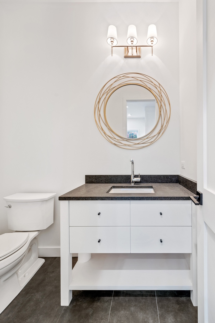 1816 Walnut Avenue Wilmette, IL 60091 - Photo 8 of 22 a bathroom with a sink a toilet and a mirror