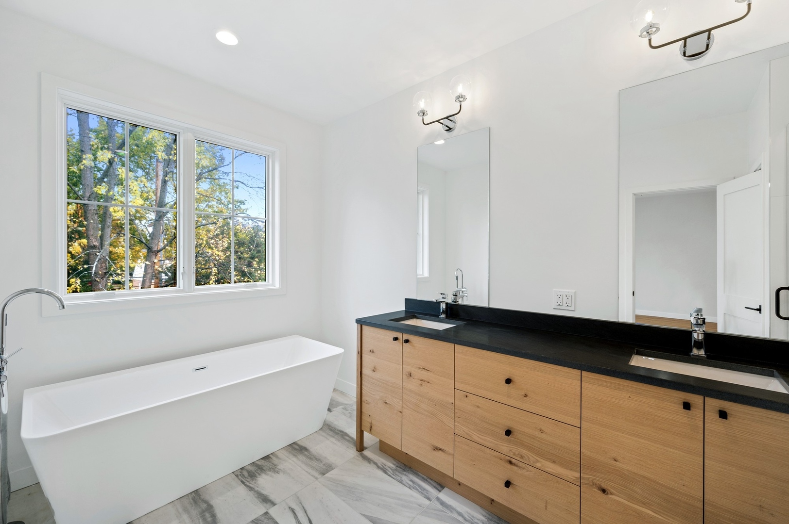 1816 Walnut Avenue Wilmette, IL 60091 - Photo 10 of 22 a bathroom with a granite countertop tub a sink and a window