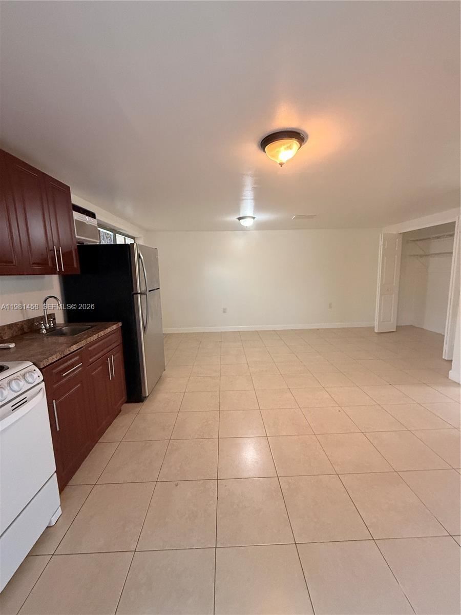 a view of kitchen with cabinets