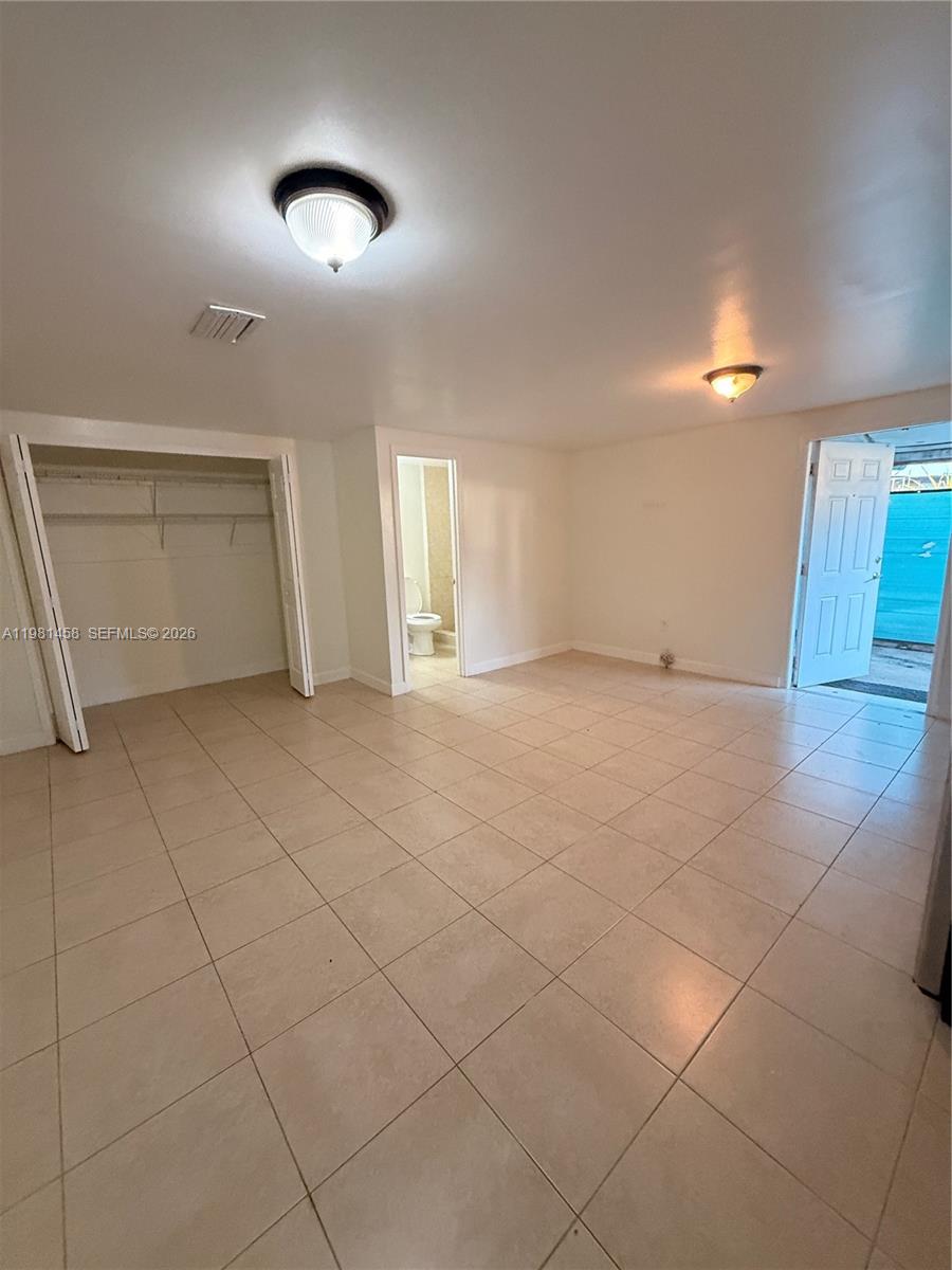 5230 Southwest 116th Avenue, Unit 3 Miami, FL 33165 - Photo 3 of 3 a view of an empty room with a window