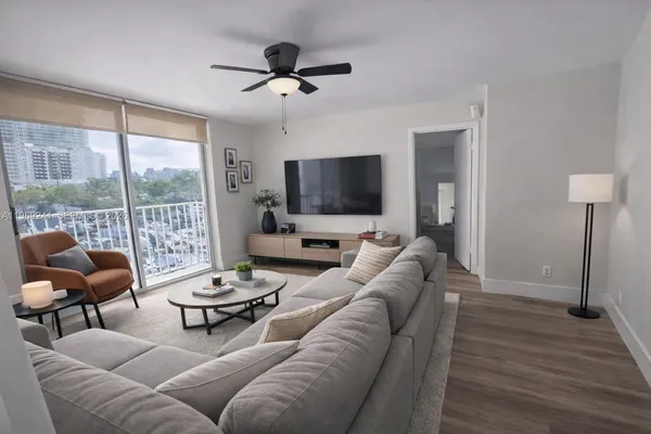 a living room with furniture and a flat screen tv