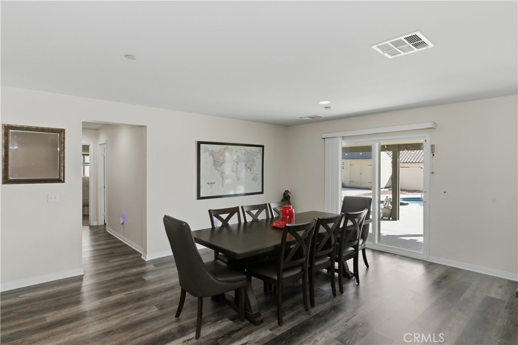 20583 Spring Street Riverside, CA 92507 - Photo 11 of 53 a view of a dining room with furniture and wooden floor