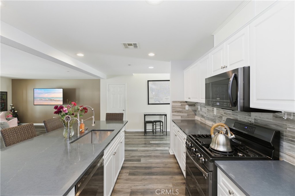 20583 Spring Street Riverside, CA 92507 - Photo 13 of 53 a kitchen with a sink appliances and a counter top space