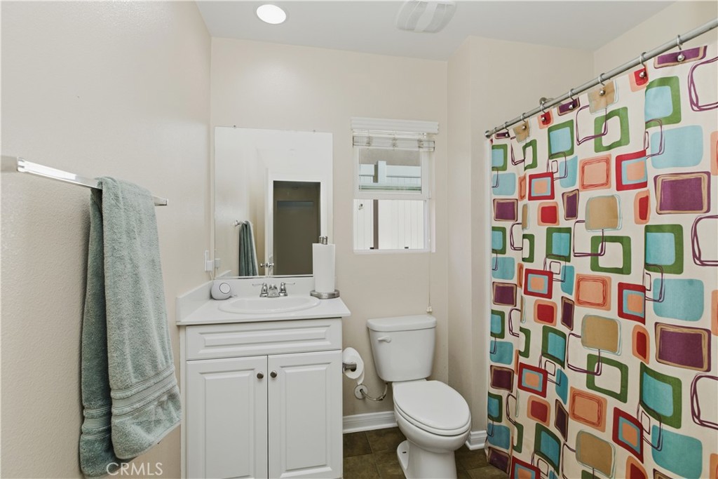 20583 Spring Street Riverside, CA 92507 - Photo 23 of 53 a bathroom with a sink toilet vanity and shower