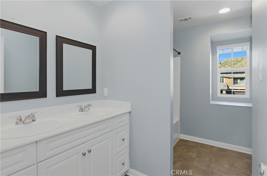 20583 Spring Street Riverside, CA 92507 - Photo 28 of 53 a bathroom with a sink and a mirror