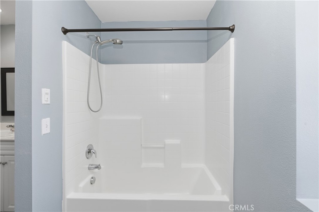 20583 Spring Street Riverside, CA 92507 - Photo 29 of 53 a bathroom with a shower and a bath tub