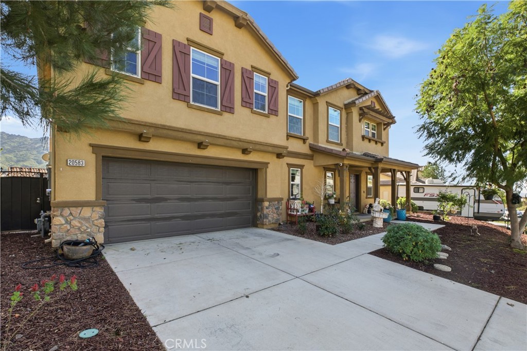 20583 Spring Street Riverside, CA 92507 - Photo 3 of 53 a front view of a house with garden