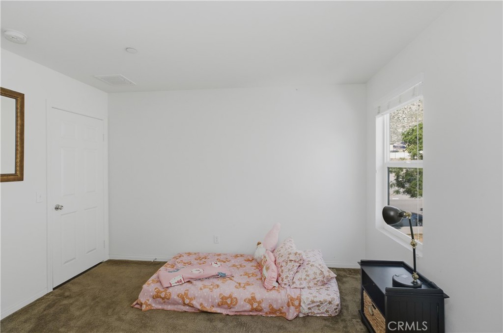 20583 Spring Street Riverside, CA 92507 - Photo 32 of 53 a bedroom with a bed and a window