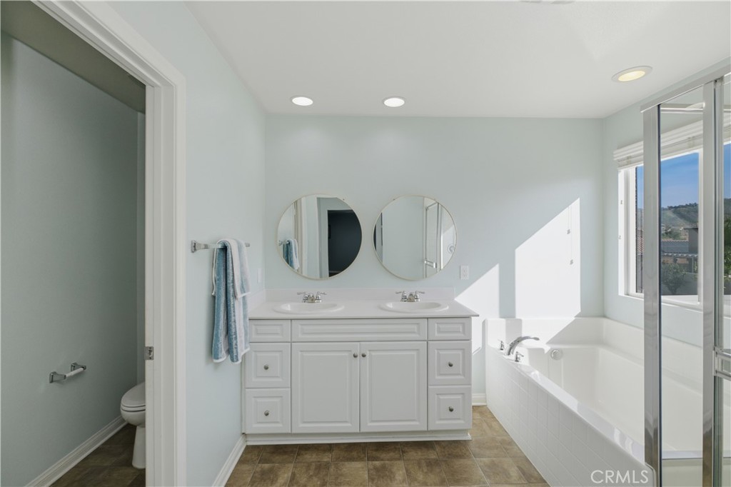 20583 Spring Street Riverside, CA 92507 - Photo 38 of 53 a bathroom with a sink a mirror and bathtub