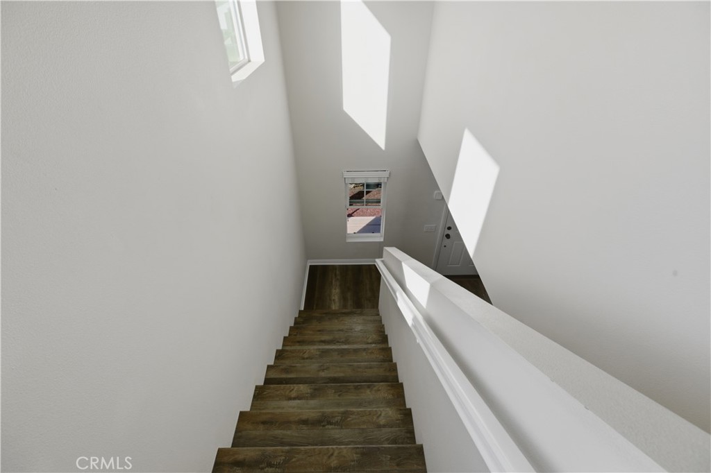 20583 Spring Street Riverside, CA 92507 - Photo 40 of 53 a view of a hallway with wooden floor and entryway