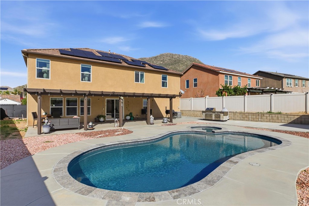 20583 Spring Street Riverside, CA 92507 - Photo 42 of 53 a view of a house with swimming pool and sitting area