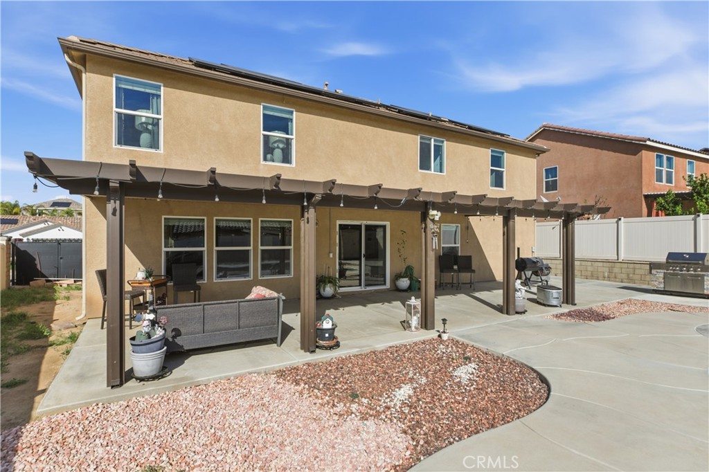 20583 Spring Street Riverside, CA 92507 - Photo 52 of 53 a view of a house with a barbeque and wooden fence