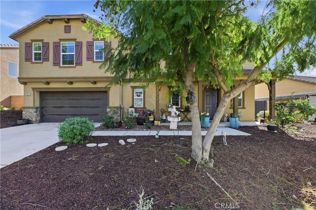 20583 Spring Street Riverside, CA 92507 - Photo 7 of 53 a front view of a house with garden