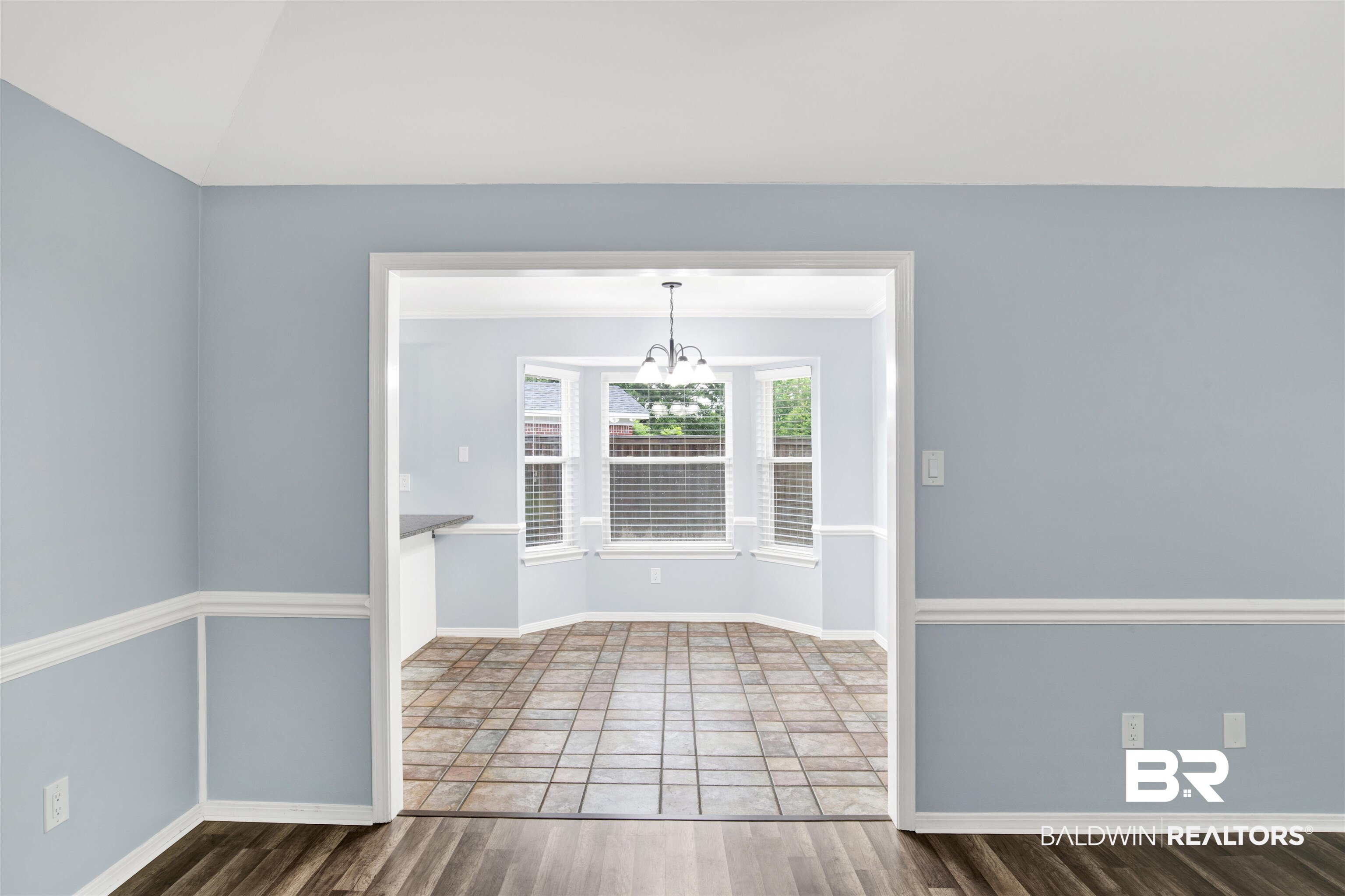 3011 Olde Gate Road Mobile, AL 36695 - Photo 14 of 35 Unfurnished room with a chandelier, wood finished floors, and lofted ceiling