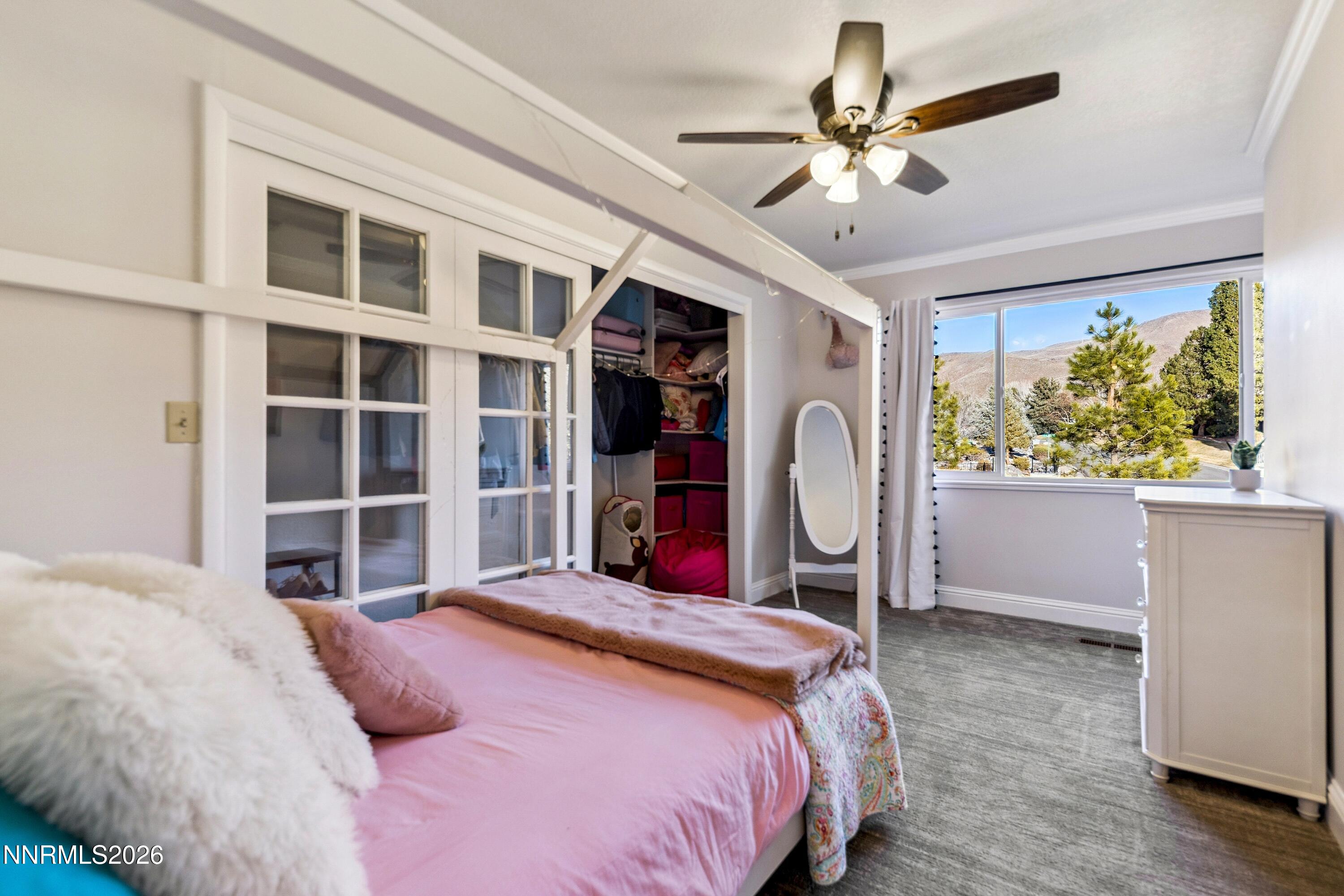 3620 East Hidden Valley Drive Reno, NV 89502 - Photo 44 of 67 a bedroom with a large bed and a large window